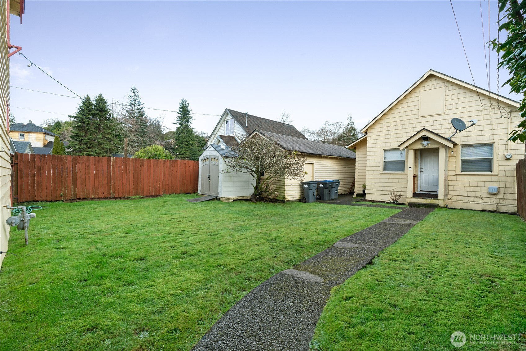 324 North F Street Aberdeen, WA 98520 - Photo 25 of 32 a view of a yard in front of a house with large tree