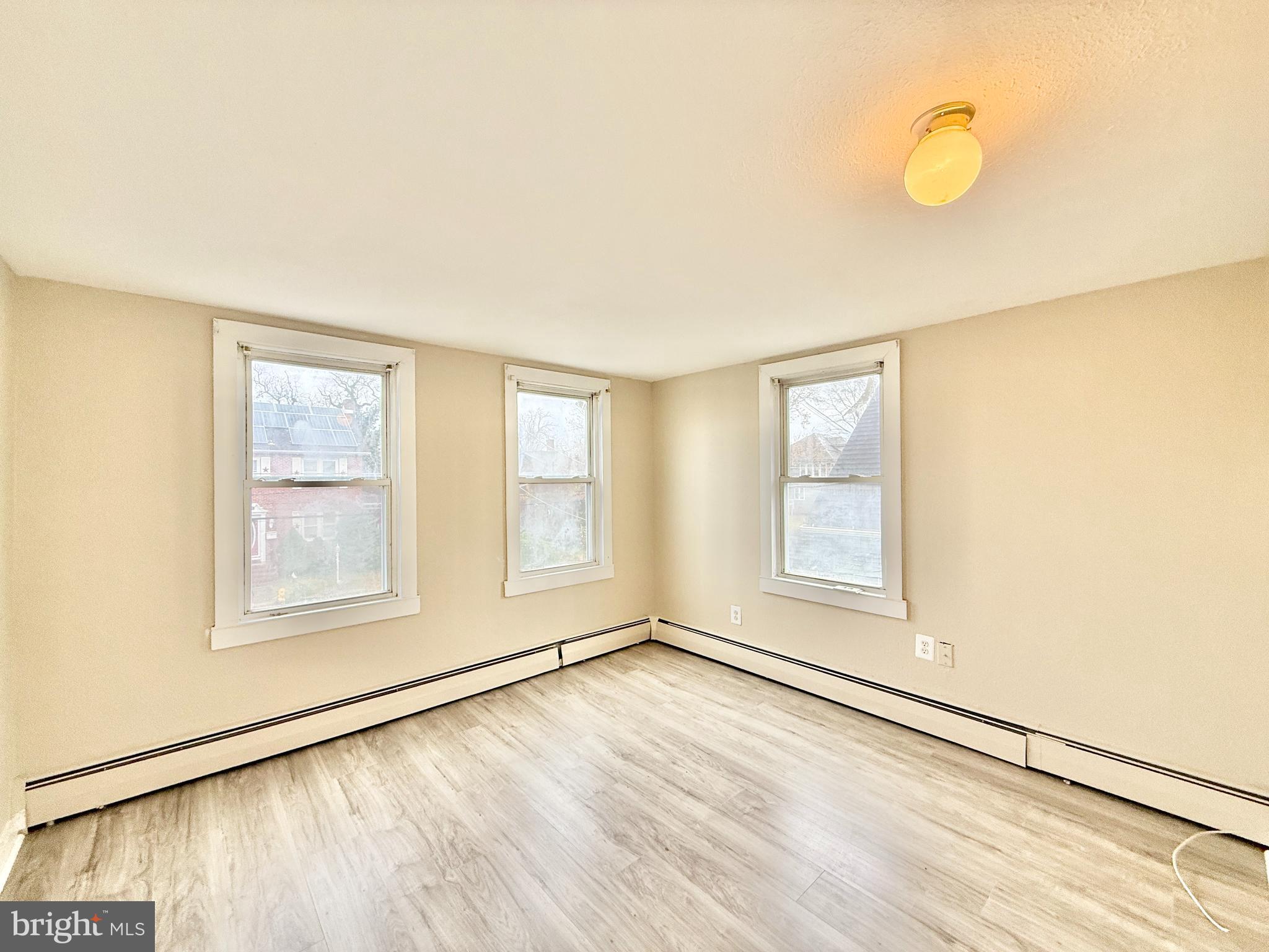 5 Craven Avenue Salem, NJ 08079 - Photo 11 of 13 an empty room with wooden floor and windows