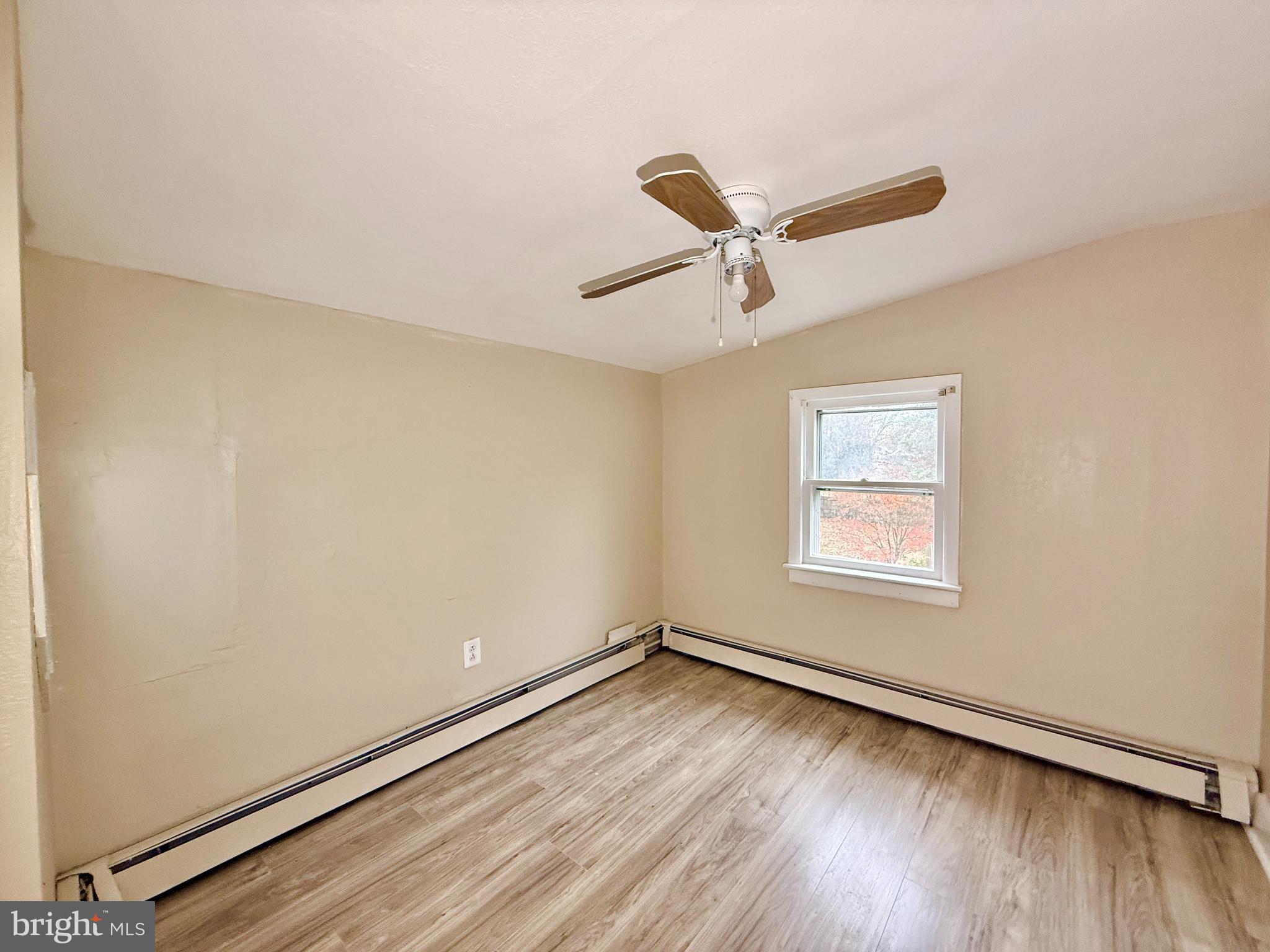 5 Craven Avenue Salem, NJ 08079 - Photo 8 of 13 an empty room with a window and a ceiling fan