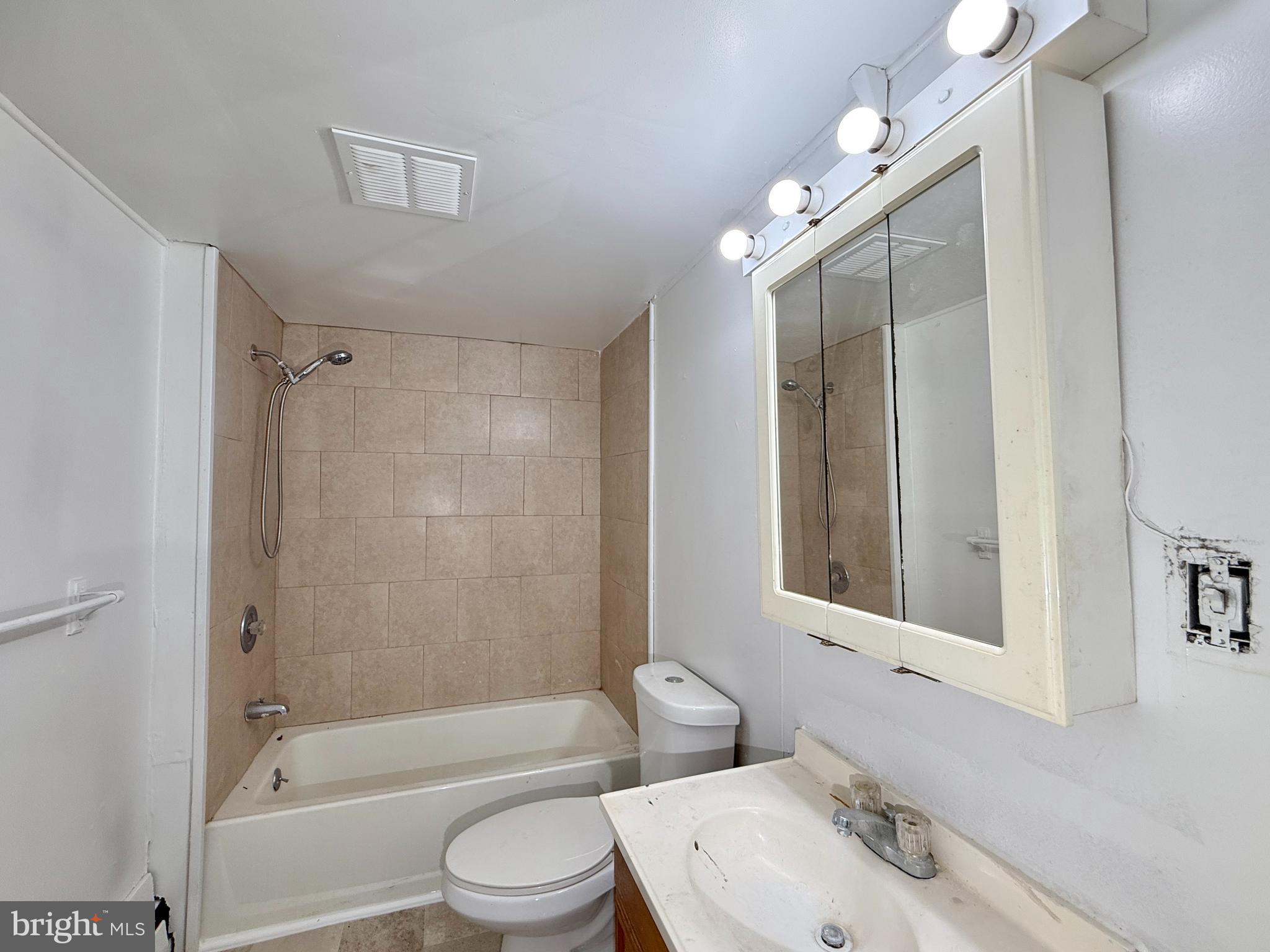 5 Craven Avenue Salem, NJ 08079 - Photo 9 of 13 a bathroom with a bathtub shower sink vanity mirror and toilet