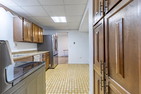 a kitchen with stainless steel appliances a refrigerator sink and stove