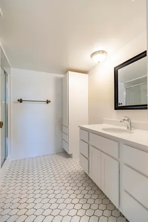 an empty room with windows and closet