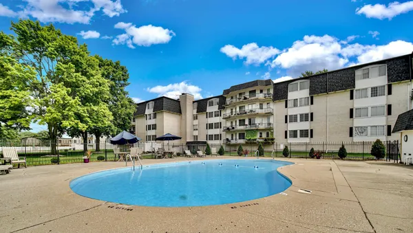 a view of a swimming pool with a yard