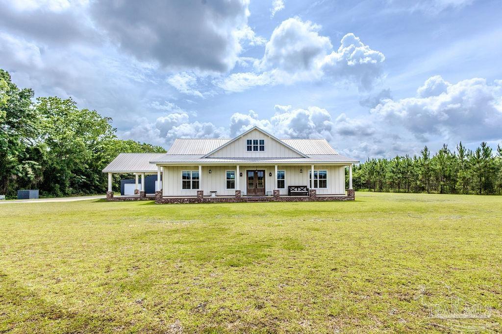 a front view of the house with a garden