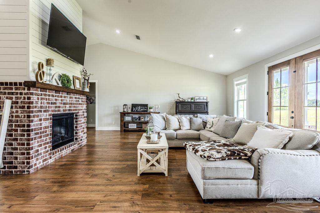 778 Griswold Road Jay, FL 32565 - Photo 11 of 57 a living room with furniture a flat screen tv and a fireplace