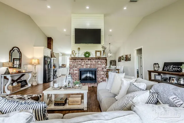a living room with fireplace furniture and a flat screen tv
