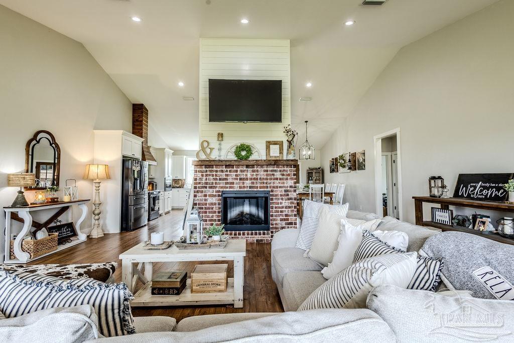 778 Griswold Road Jay, FL 32565 - Photo 13 of 57 a living room with furniture a fireplace and a flat screen tv