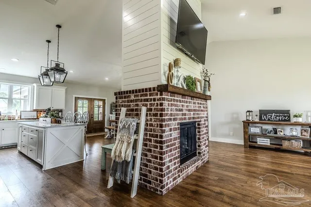 a living room with furniture a flat screen tv and a fireplace