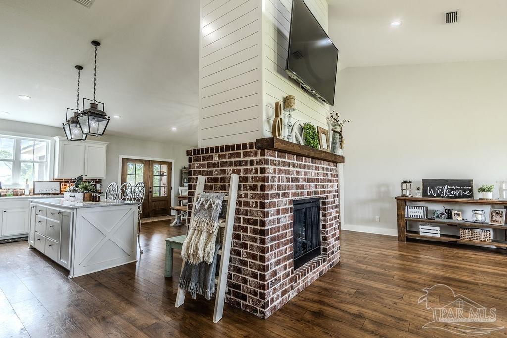 778 Griswold Road Jay, FL 32565 - Photo 14 of 57 a view of a livingroom with furniture wooden floor kitchen view and a chandelier