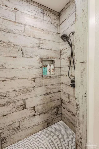 a bathroom with a sink and mirror with bathtub