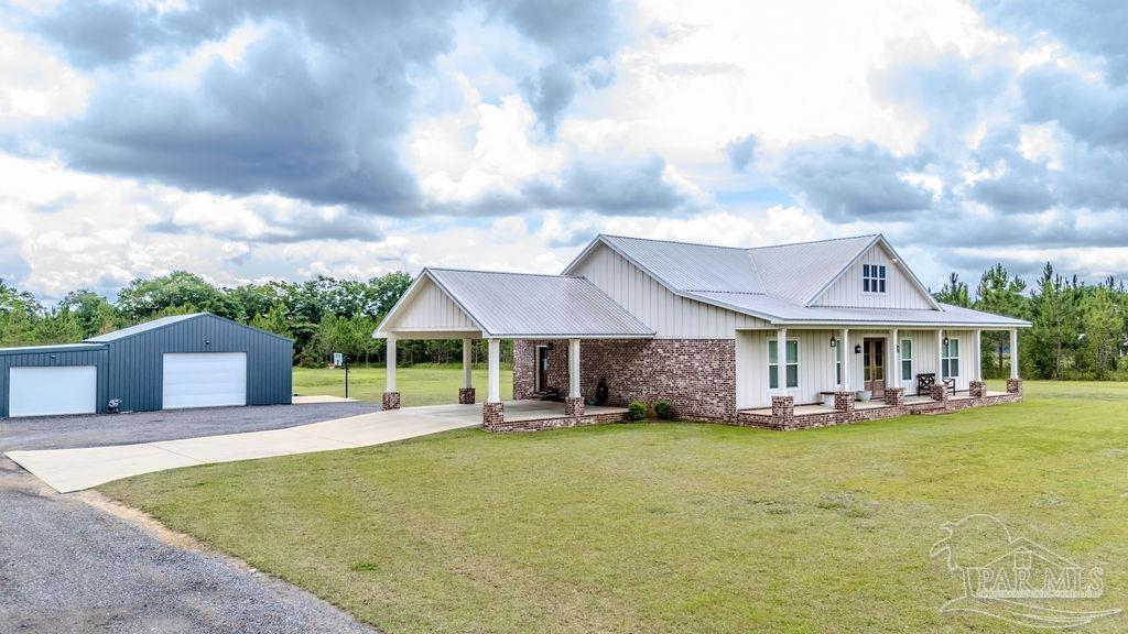 778 Griswold Road Jay, FL 32565 - Photo 2 of 57 a front view of a house with a yard table and chairs