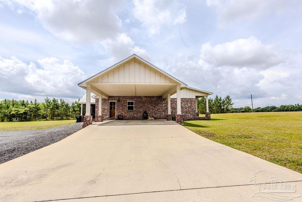 778 Griswold Road Jay, FL 32565 - Photo 31 of 57 a front view of house with yard and trees