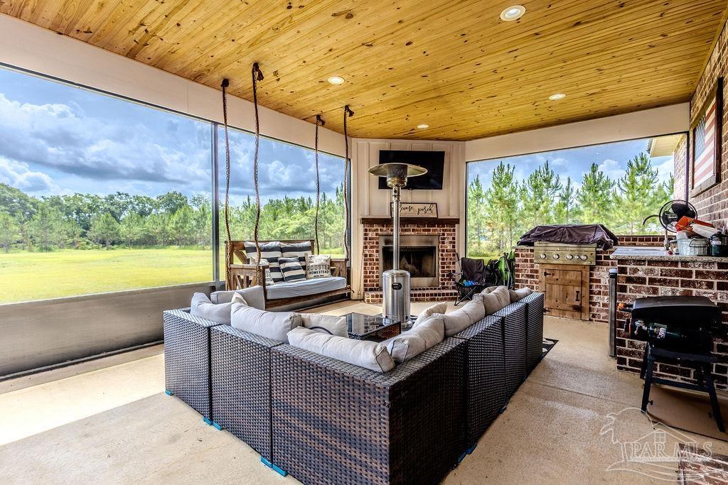 778 Griswold Road Jay, FL 32565 - Photo 34 of 57 a living room with patio furniture and a floor to ceiling window