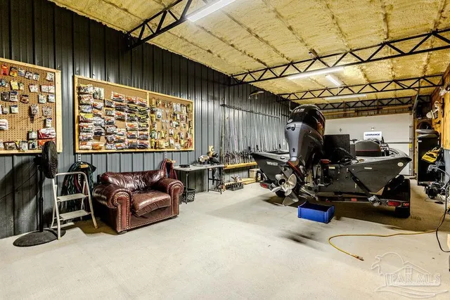 a front view of a house with swimming pool and green space