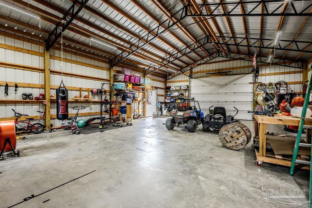 778 Griswold Road Jay, FL 32565 - Photo 41 of 57 a view of a garage with a bike and car