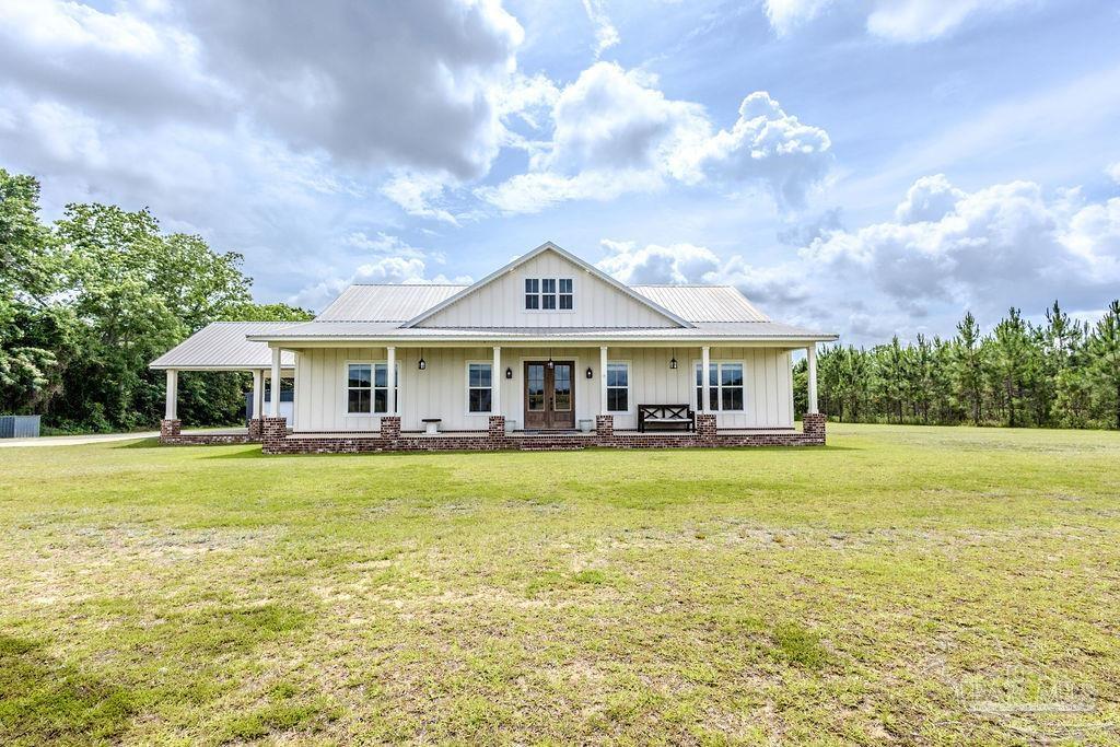 778 Griswold Road Jay, FL 32565 - Photo 43 of 57 a front view of a house with swimming pool and green space