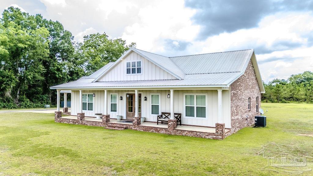 778 Griswold Road Jay, FL 32565 - Photo 48 of 57 a view of a patio with table and chairs potted plants with wooden fence