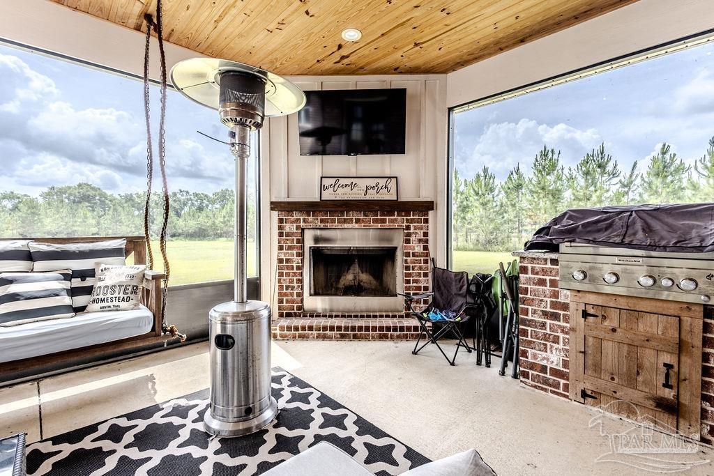 778 Griswold Road Jay, FL 32565 - Photo 5 of 57 a living room with furniture a flat screen tv and a fireplace