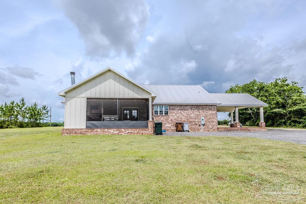 778 Griswold Road Jay, FL 32565 - Photo 55 of 57 a front view of a house with a yard and garage