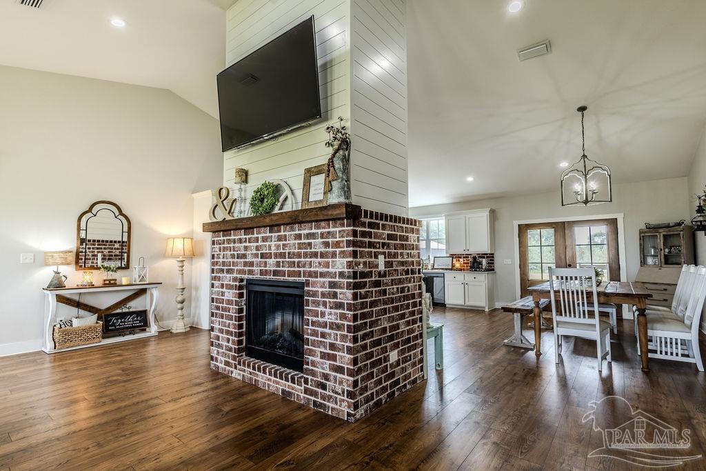 778 Griswold Road Jay, FL 32565 - Photo 7 of 57 a living room with furniture a flat screen tv and a fireplace