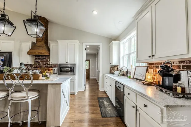 a very nice looking kitchen with a large window cabinets and stainless steel appliances
