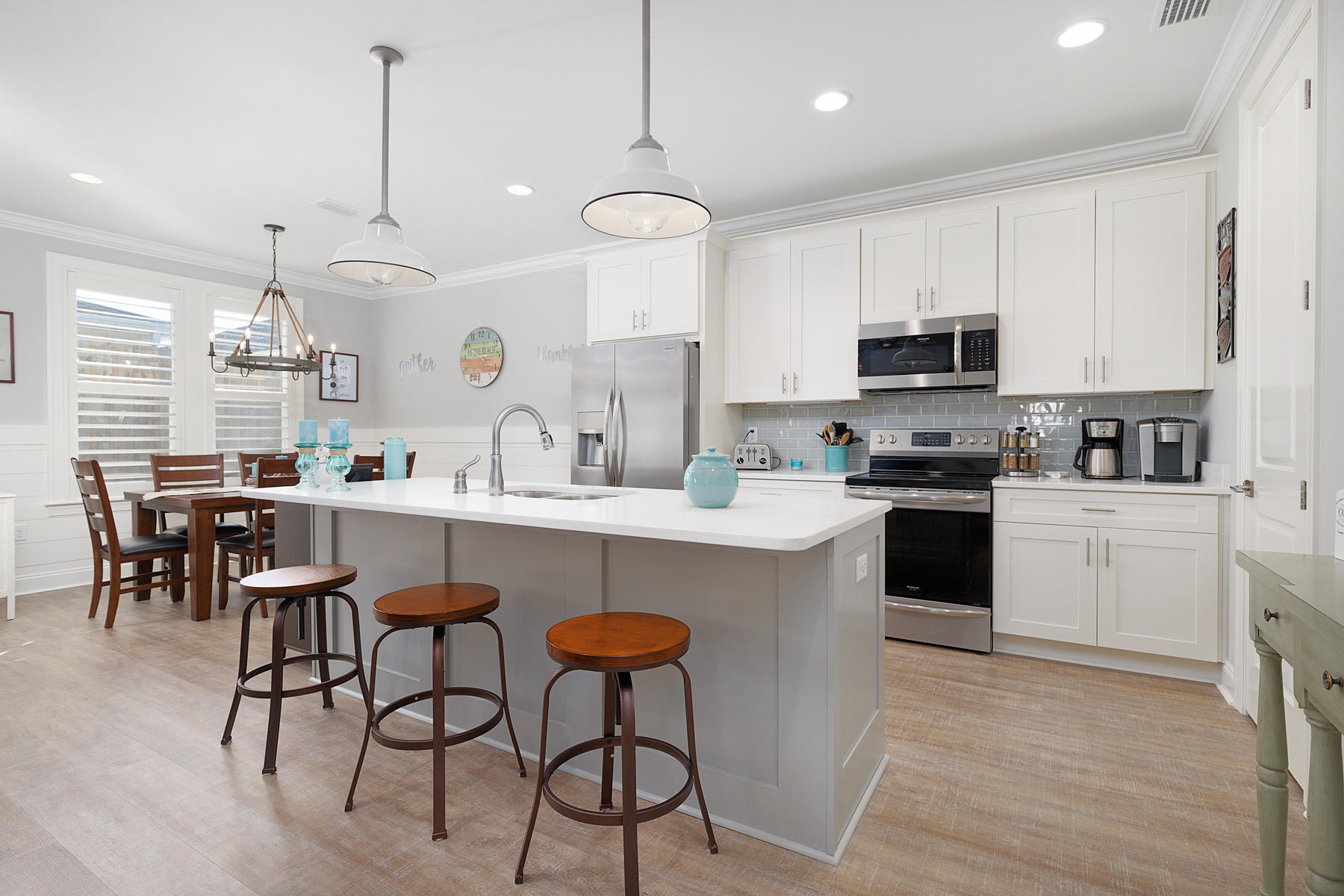 22 Roundwood Drive, Unit LOT 294 Watersound, FL 32461 - Photo 11 of 32 a kitchen with kitchen island granite countertop a sink a center island and cabinets