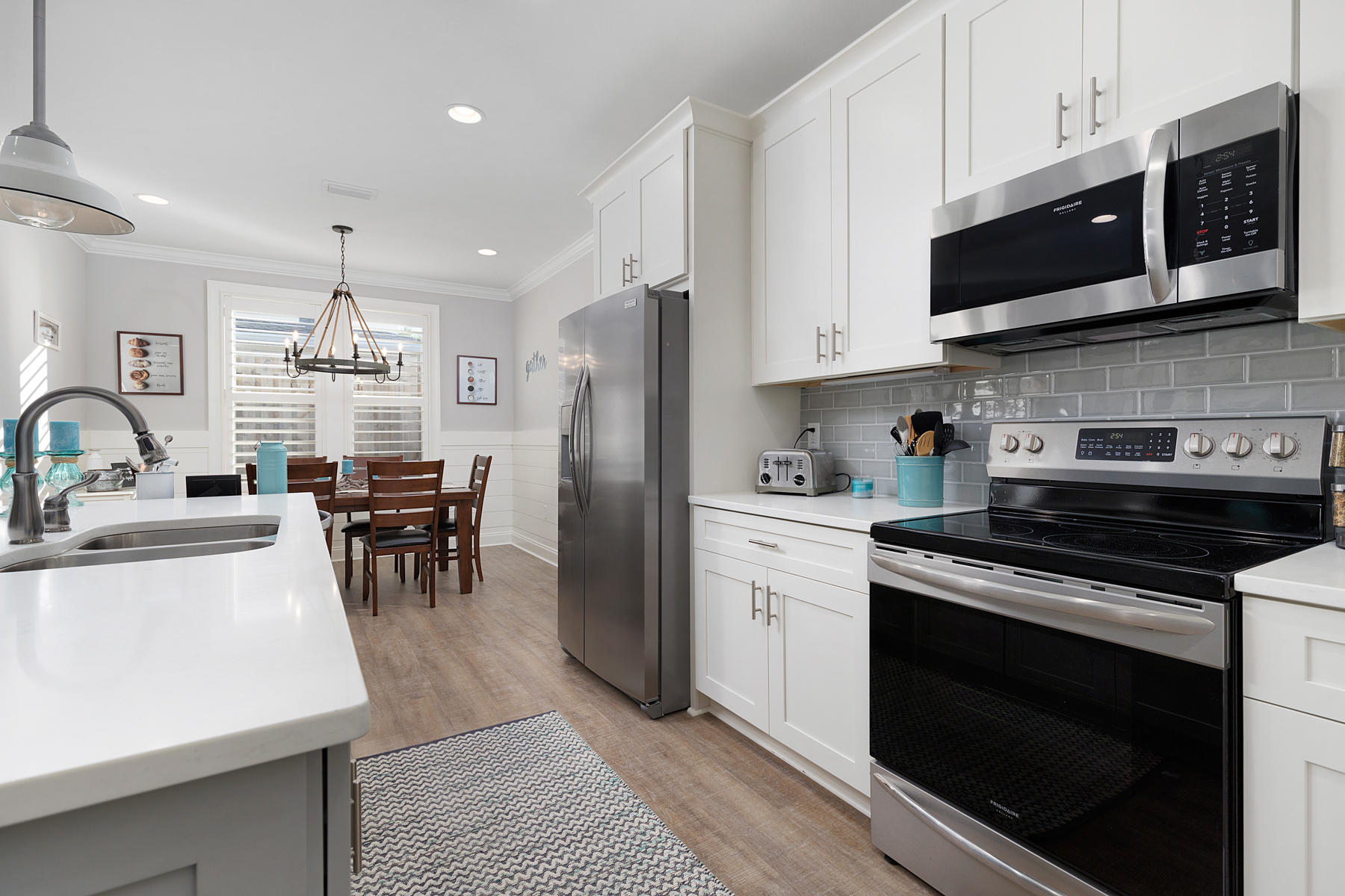 22 Roundwood Drive, Unit LOT 294 Watersound, FL 32461 - Photo 13 of 32 a kitchen with stainless steel appliances a stove a sink a microwave and cabinets