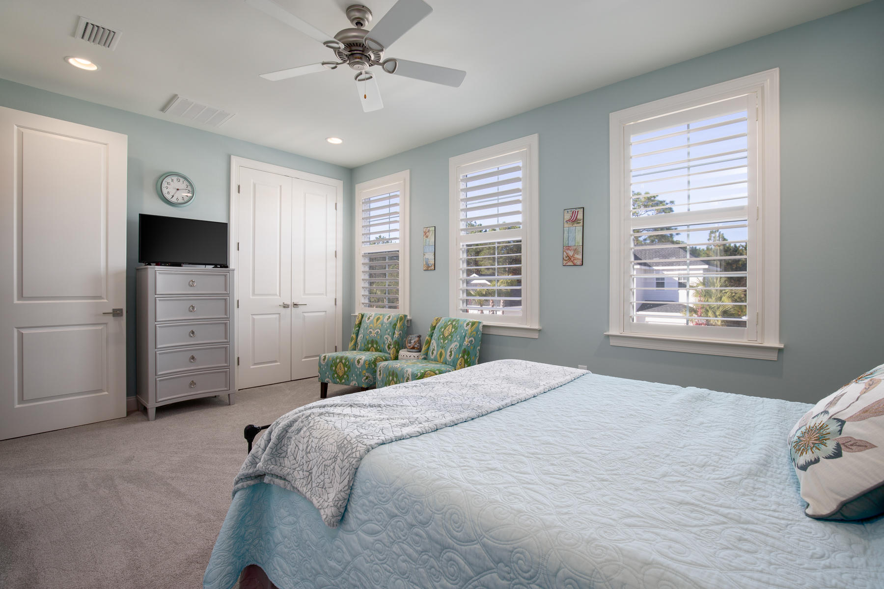 22 Roundwood Drive, Unit LOT 294 Watersound, FL 32461 - Photo 19 of 32 a spacious bedroom with a bed a dresser and a window