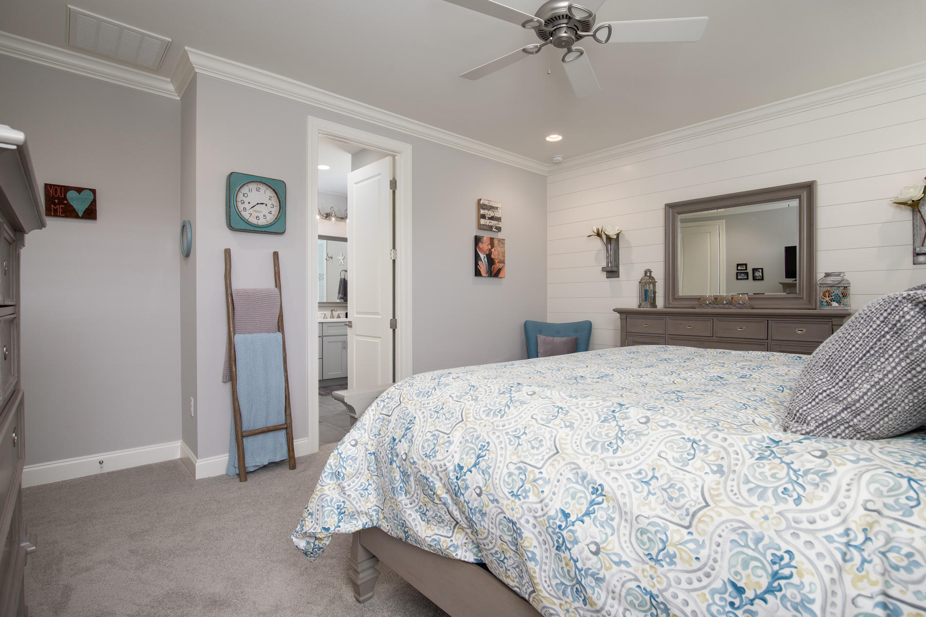 22 Roundwood Drive, Unit LOT 294 Watersound, FL 32461 - Photo 21 of 32 a bedroom with a bed and a chandelier