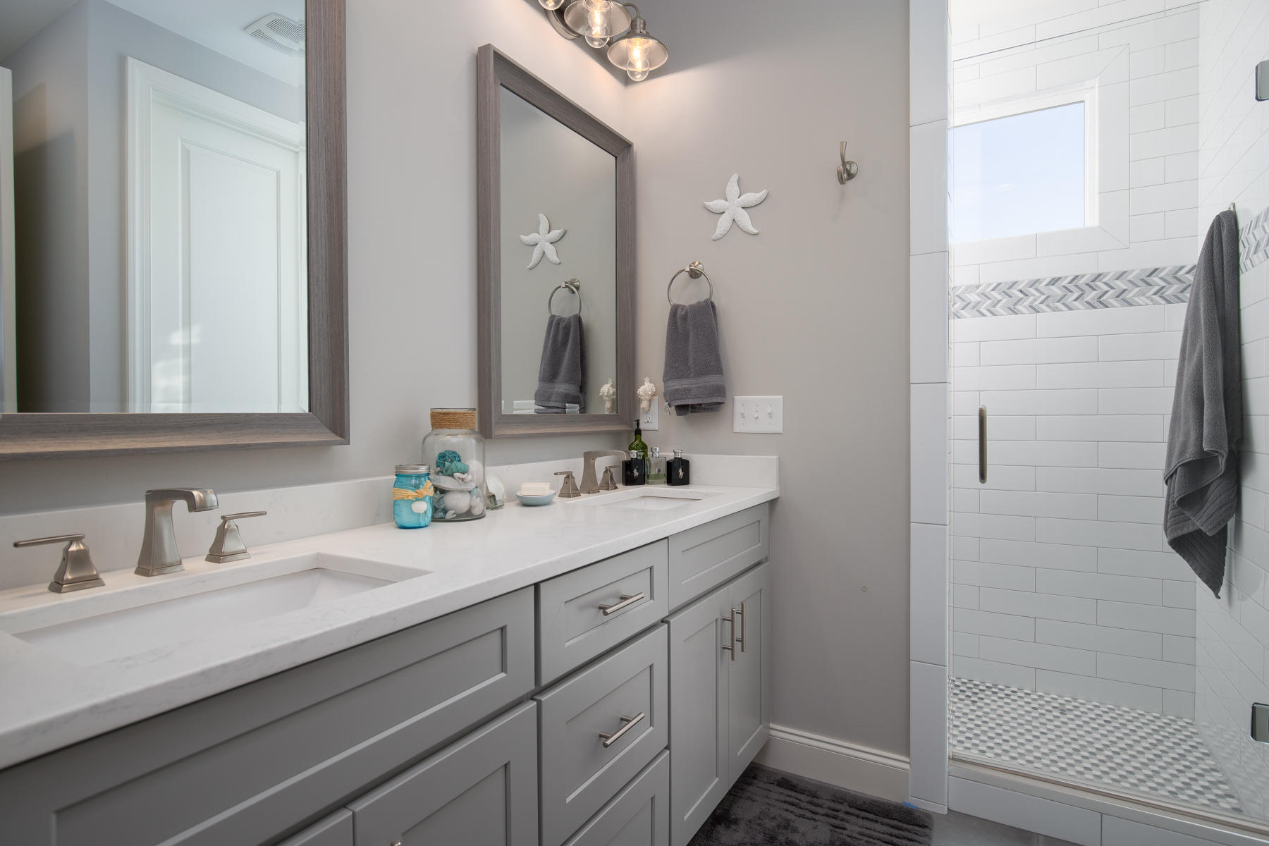 22 Roundwood Drive, Unit LOT 294 Watersound, FL 32461 - Photo 22 of 32 a bathroom with a double vanity sink mirror and shower