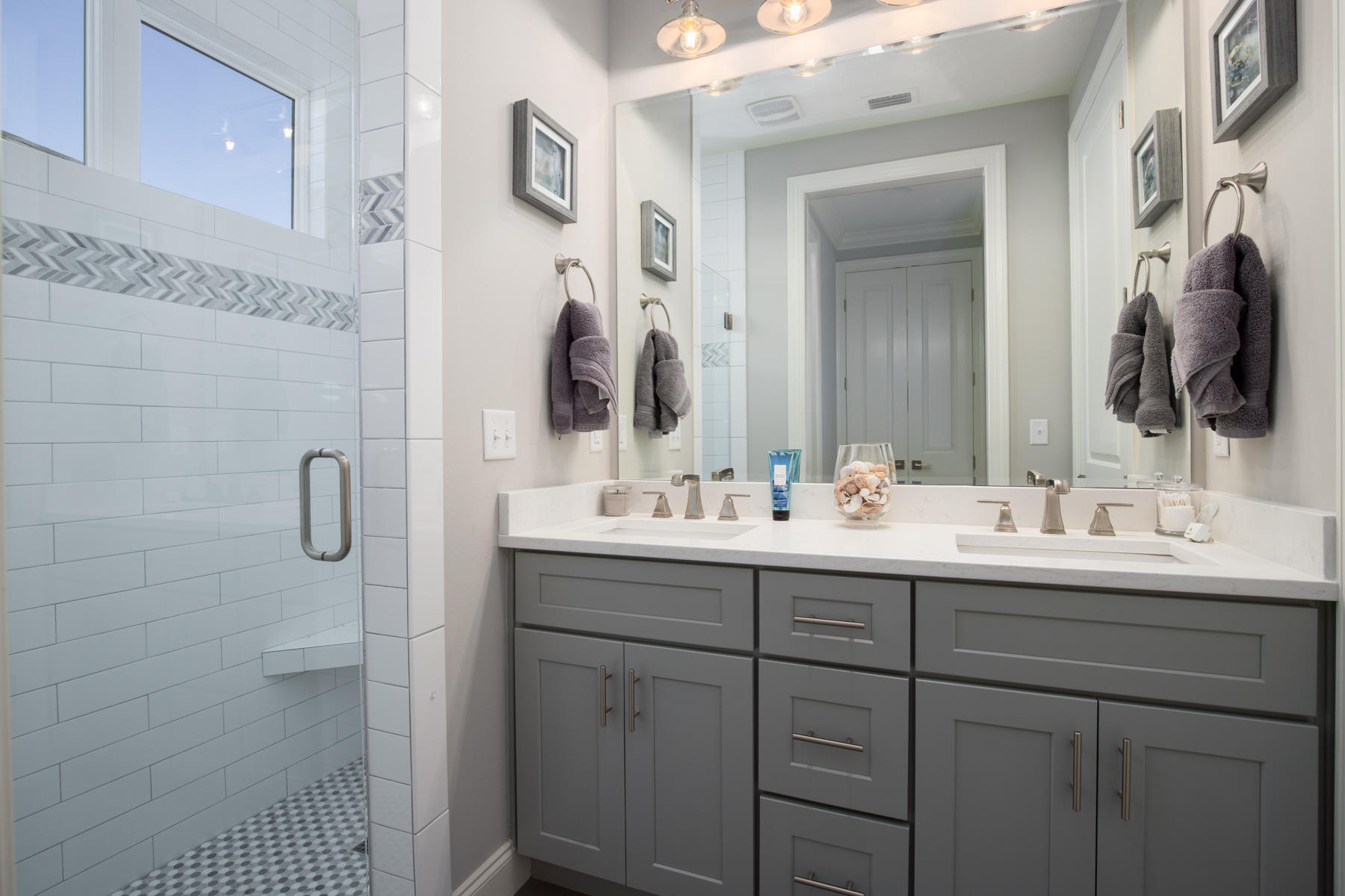 22 Roundwood Drive, Unit LOT 294 Watersound, FL 32461 - Photo 24 of 32 a bathroom with a double vanity sink and mirror
