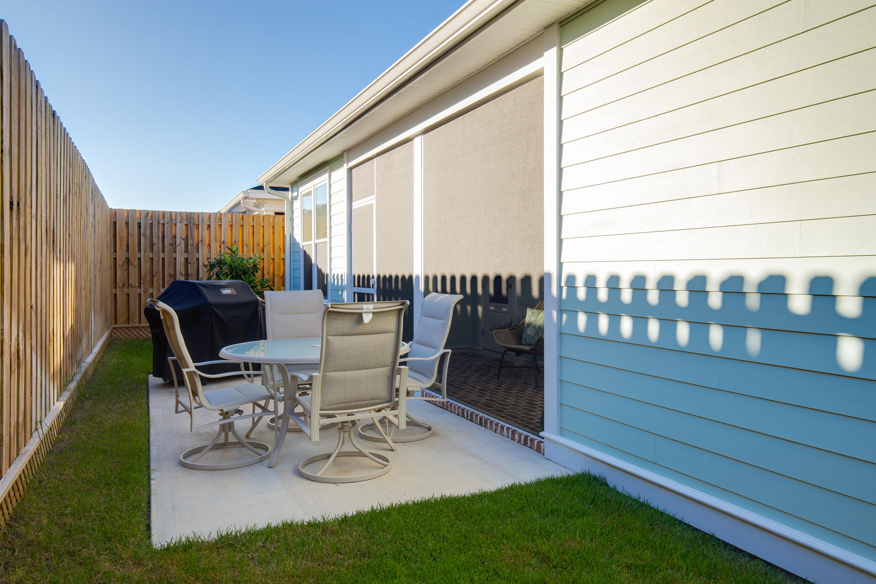 22 Roundwood Drive, Unit LOT 294 Watersound, FL 32461 - Photo 26 of 32 a view of a patio with a dining table and chairs