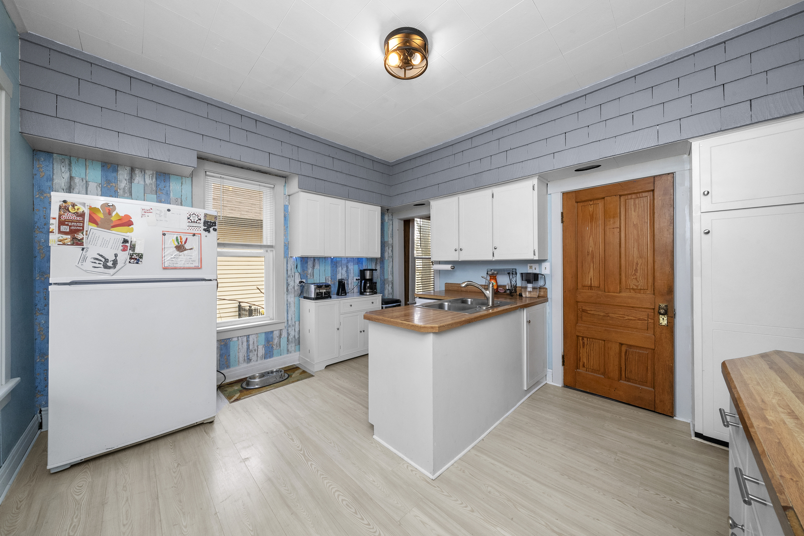 516 Catherine Street Ottawa, IL 61350 - Photo 12 of 38 a kitchen with refrigerator and cabinets
