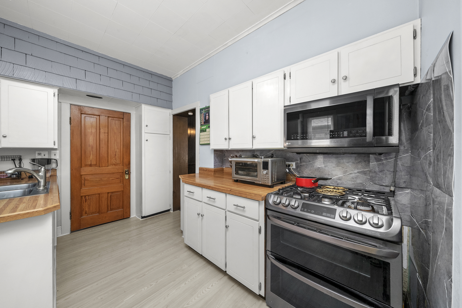516 Catherine Street Ottawa, IL 61350 - Photo 13 of 38 a kitchen with stainless steel appliances a stove a microwave and cabinets