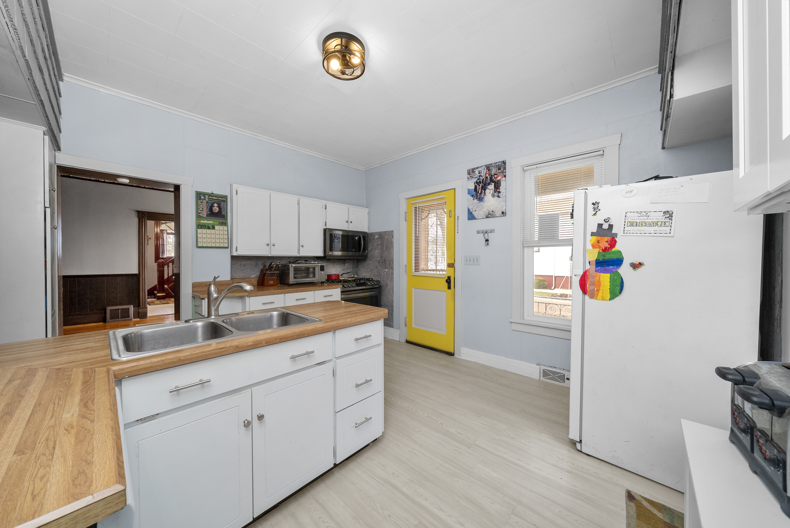 516 Catherine Street Ottawa, IL 61350 - Photo 15 of 38 a kitchen with a refrigerator and a sink