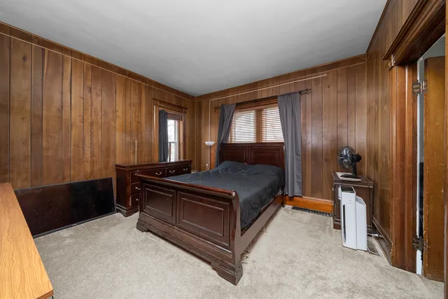 a bed sitting in a room next to a window