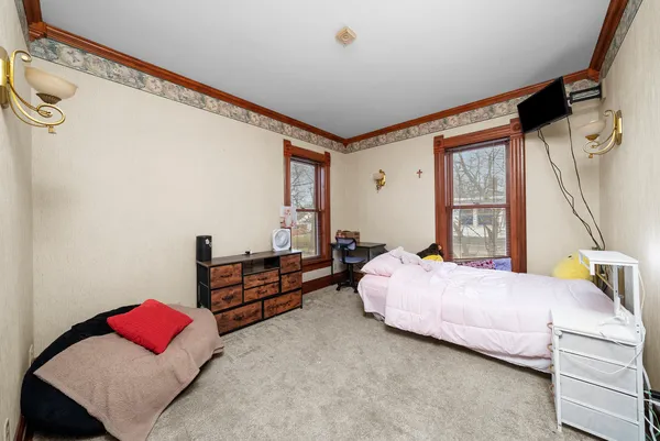 a bedroom with furniture and a window
