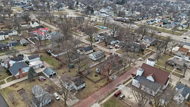an aerial view of residential houses with outdoor space and lake view