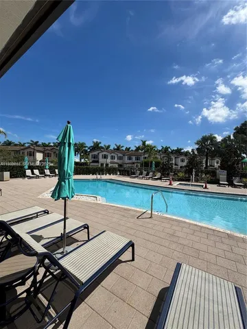 a view of a patio with swimming pool and outdoor seating