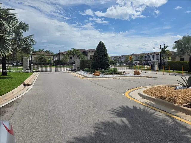 a view of a white house with a yard and table and chairs