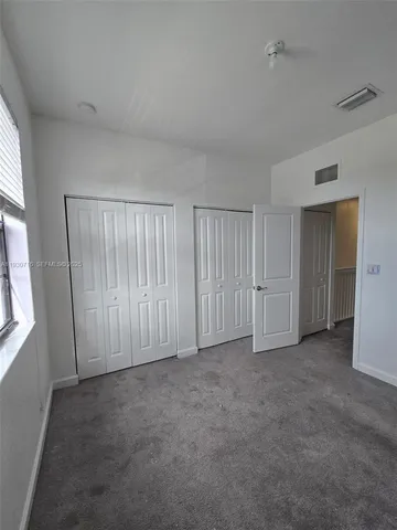 an empty room with closet area