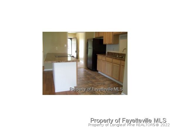 6486 Green Meadow Road Fayetteville, NC 28304 - Photo 6 of 10 a open kitchen with a sink and cabinets