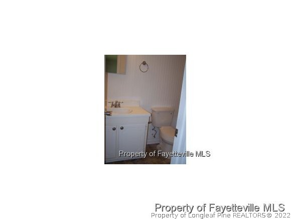 6486 Green Meadow Road Fayetteville, NC 28304 - Photo 9 of 10 a picture of a room that has a mirror and a toilet in it