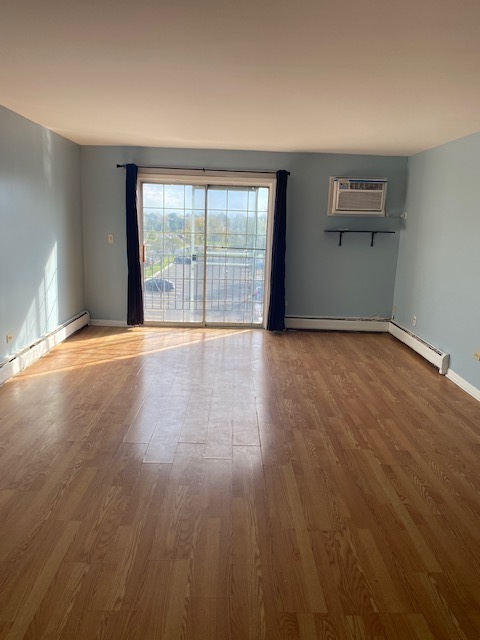 143 West Elk Trail, Unit 342 Carol Stream, IL 60188 - Photo 2 of 13 a view of an empty room with wooden floor and a window