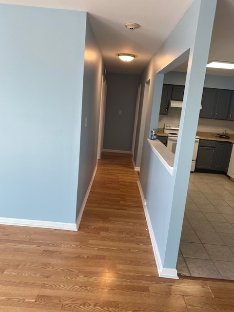 143 West Elk Trail, Unit 342 Carol Stream, IL 60188 - Photo 5 of 13 a view of a hallway with wooden floor and staircase