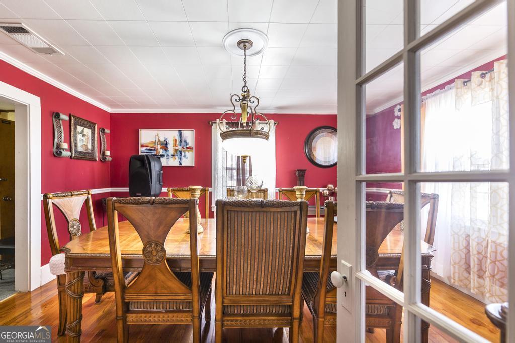 751 Findley Road Pinehurst, GA 31070 - Photo 15 of 47 a view of a dining room with furniture chandelier and wooden floor