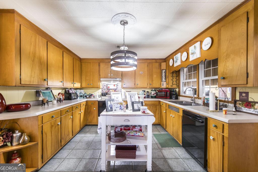 751 Findley Road Pinehurst, GA 31070 - Photo 16 of 47 a large kitchen with a large counter space a sink stainless steel appliances and cabinets