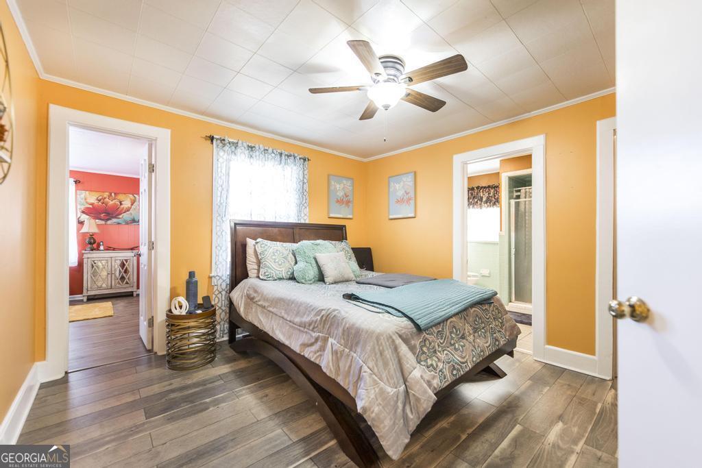 751 Findley Road Pinehurst, GA 31070 - Photo 23 of 47 a bedroom with a bed and wooden floor