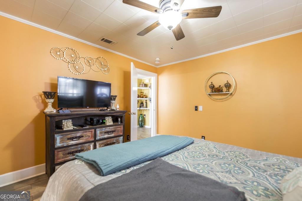 751 Findley Road Pinehurst, GA 31070 - Photo 24 of 47 a bedroom with a bed and a flat screen tv