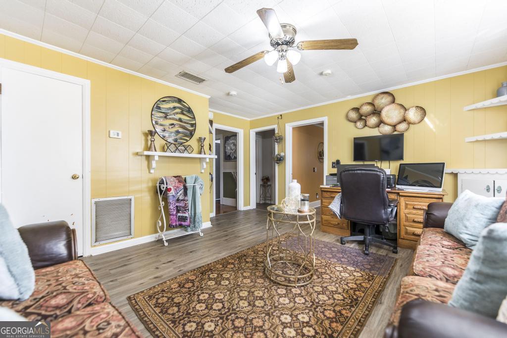 751 Findley Road Pinehurst, GA 31070 - Photo 30 of 47 a living room with furniture and a flat screen tv